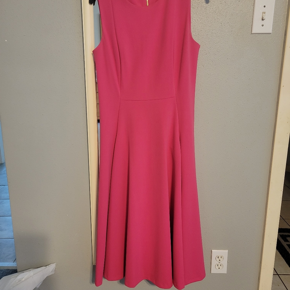 It's a pink midi dress with front pockets.